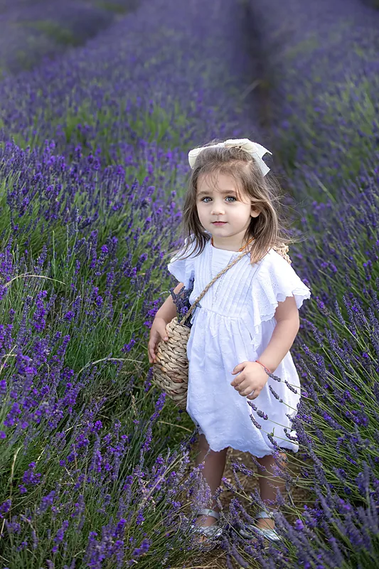 Girl in white walking through a lavender field