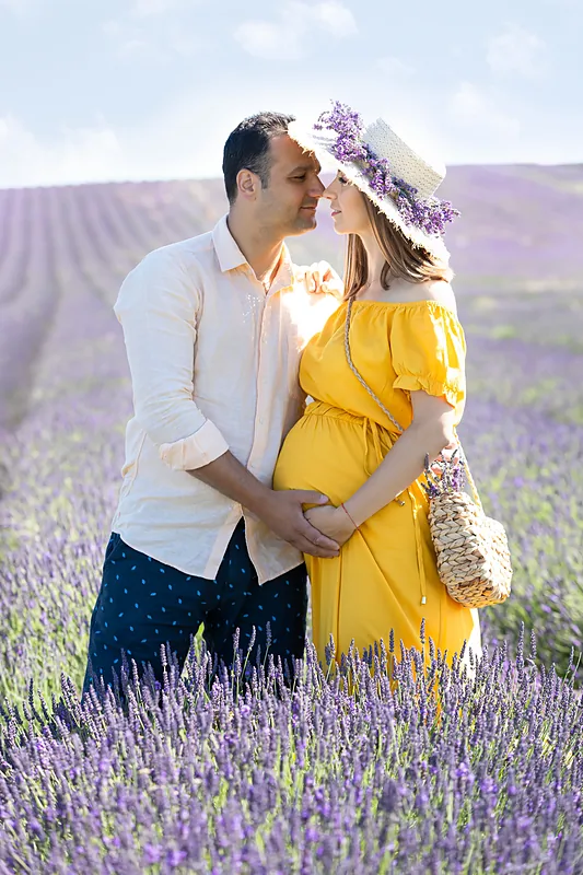 Couple embracing in a lavender field, the woman in a yellow dress and flower crown