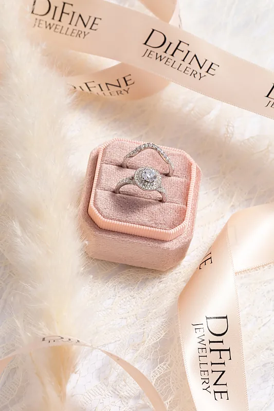 Diamond ring in a pink velvet box with a jewellery brand card