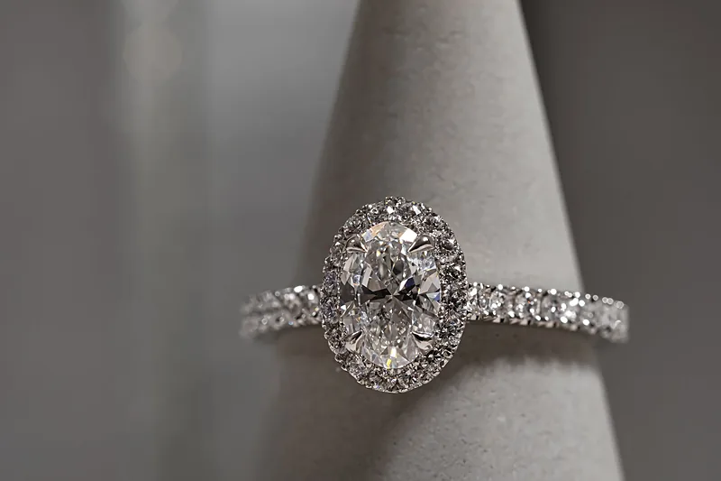 Diamond halo ring on a grey ring stand, close-up