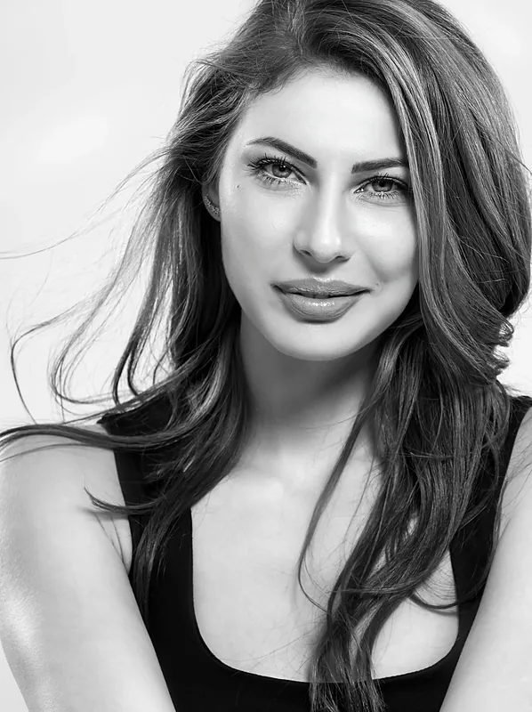 Black and white headshot of a woman with long dark hair