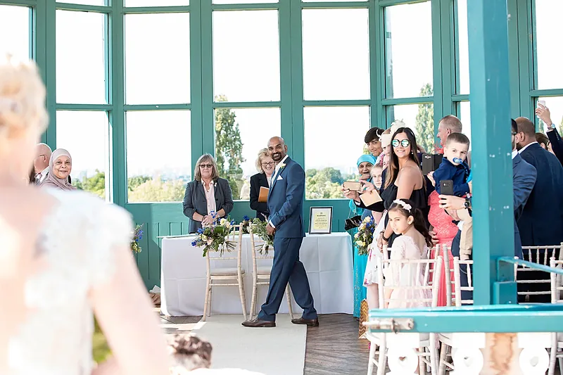 Wedding guests gathered in a light-filled conservatory